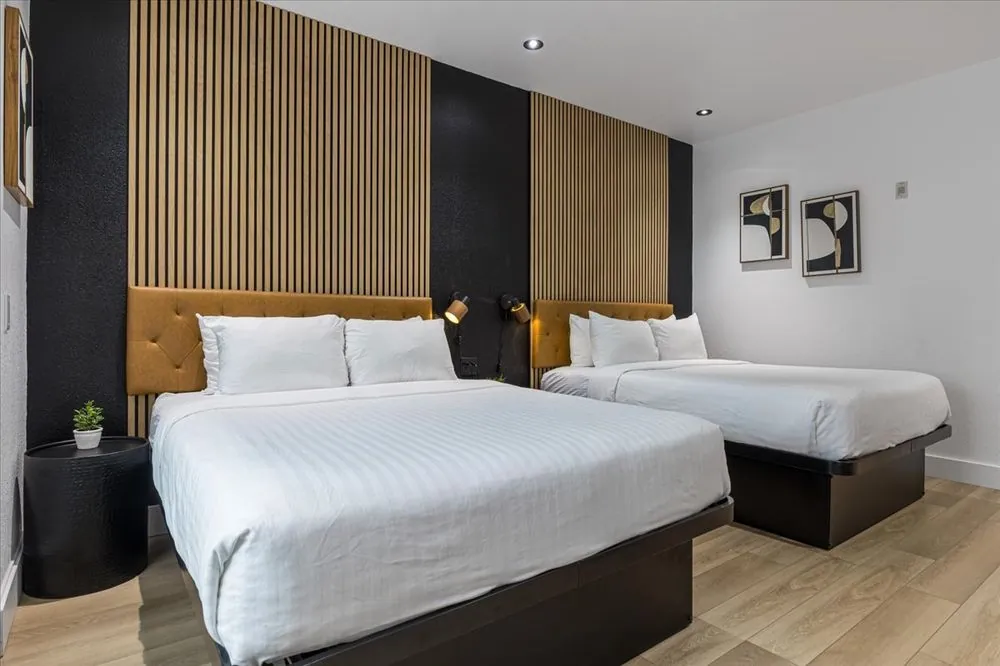 Boutique Double Queen – double queen beds with wood slat accent wall