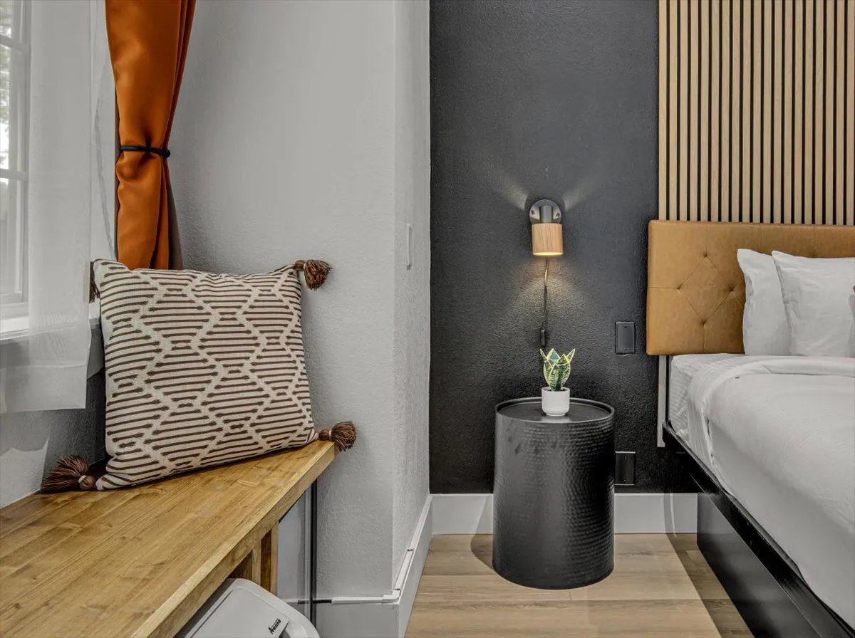Boutique King – bedside detail with patterned pillow and leather headboard
