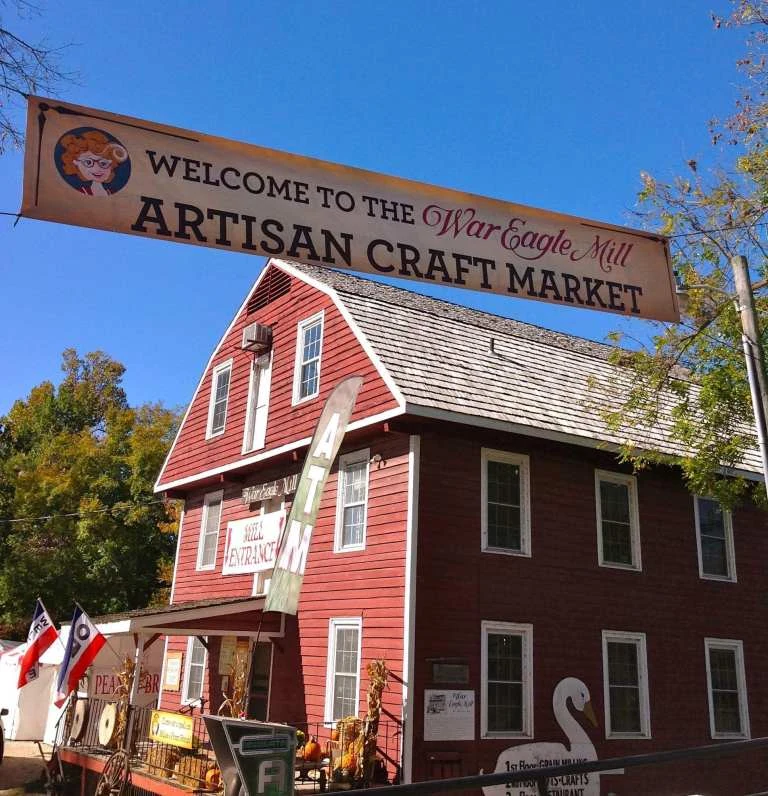 Welcome banner and red barn mill building at War Eagle Fair near Bentonville, Arkansas